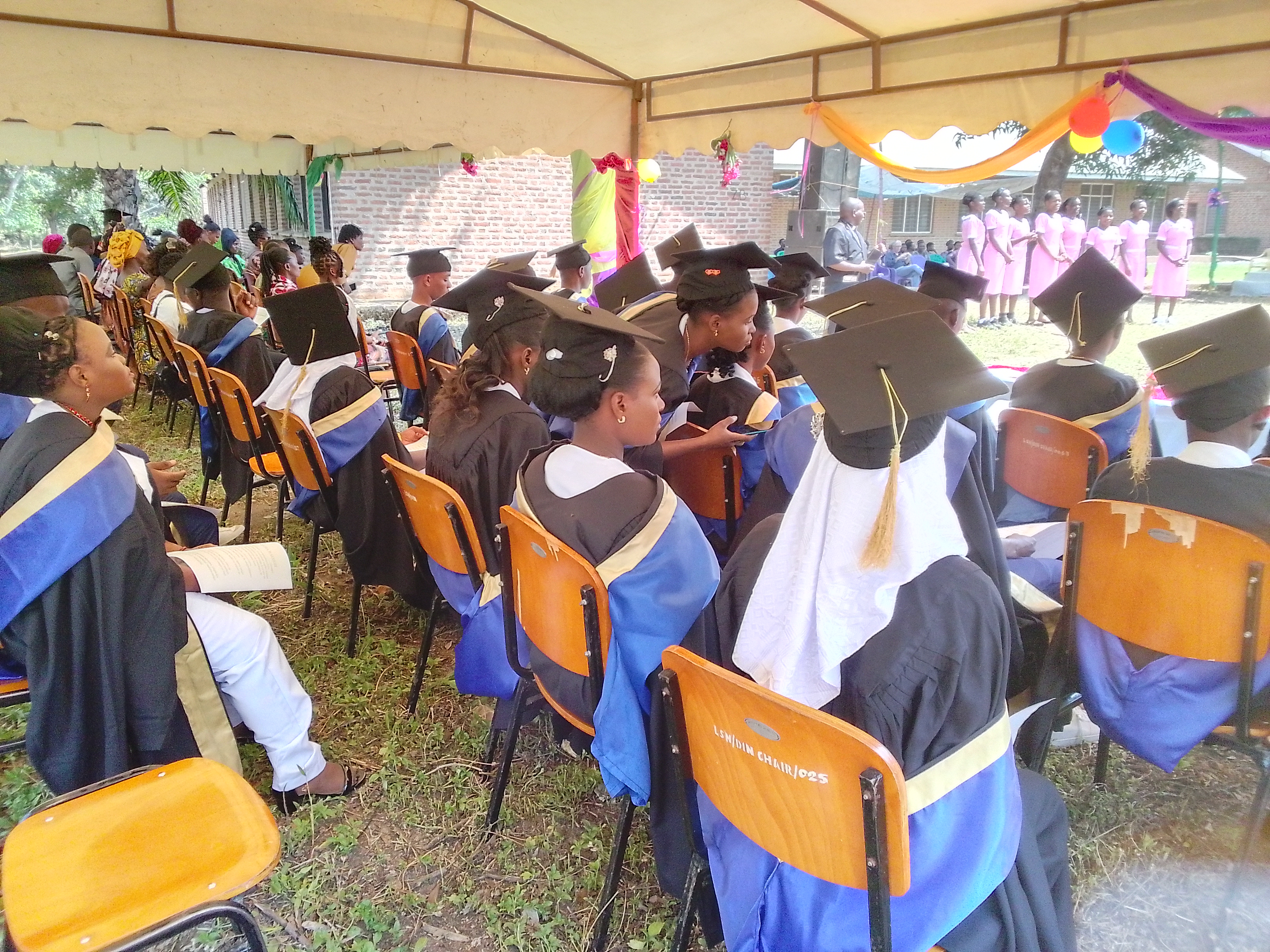 Graduates attentively following the guest of honor's address